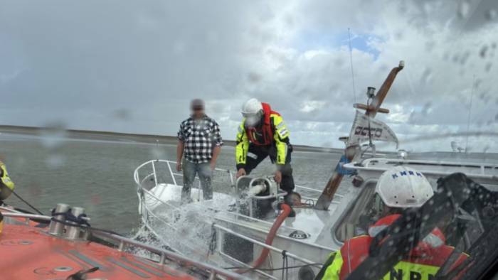 Reddingswerkers verleenden bijstand aan boord.